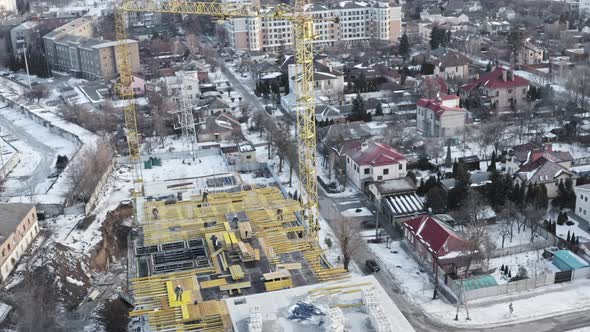 Large Construction Site with Construction Cranes and Workers Doing Work