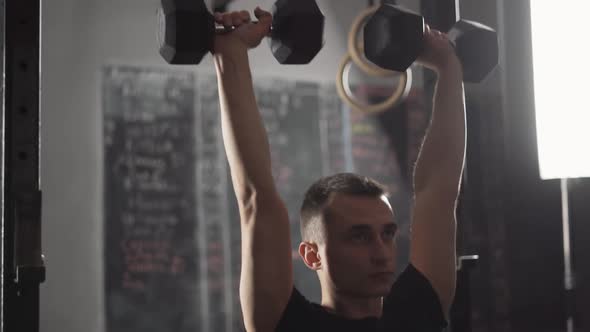 Workout Young Disabled Athlete in Wheelchair Performs Exercises with Dumbbells Gym Training and