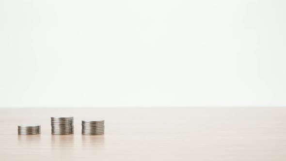 Stop motion animation Raising of coins stacks on White background and coin into a clear piggy bank