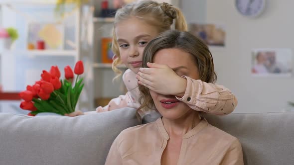 Adorable Daughter Giving Bouquet to Mom, Congratulating on Mother Day, Gratitude