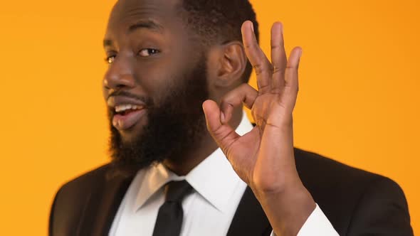 African-American Man in Suit Showing Ok Gesture, Profitable Investment Project