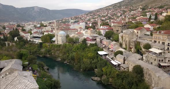 Aerial shot of Stari Most, old bridge, in Mostar. the camera slowly pulls back to reveal Stari Most