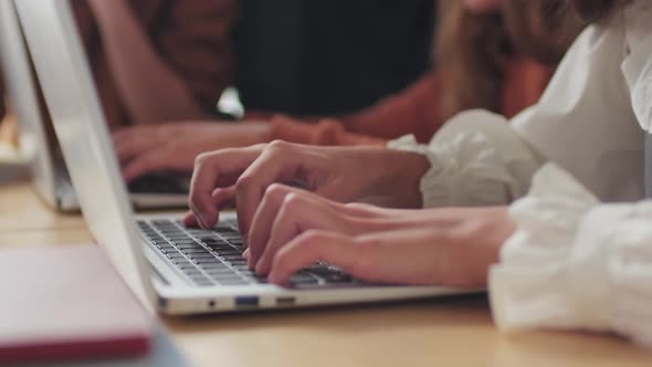 close up of girls hands working on their laptops