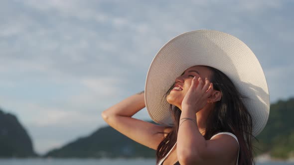 Woman In Sun Hat Shielding Eyes From Bright Sunlight