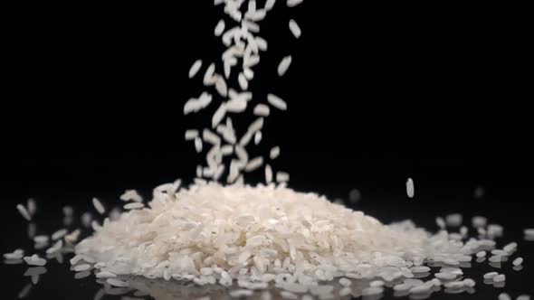 Rice Falls on a Solid Black Surface