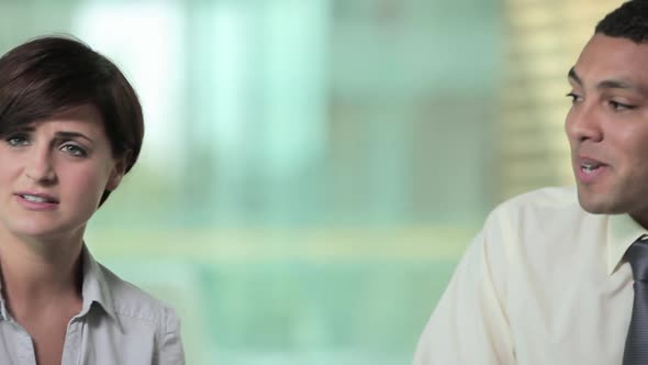 Young man and woman talking in meeting