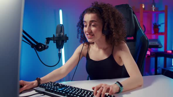 Young Woman Wearing Headphones Playing Computer Game Neon Fashion Room Winner