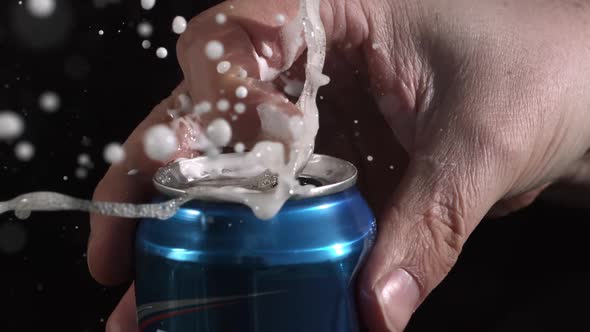 Slow motion of aluminum can opening and spraying as tab is being pulled. alt