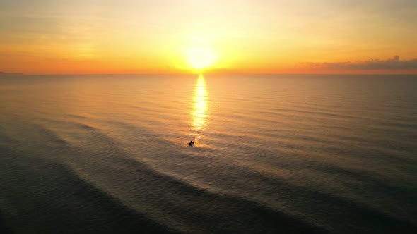 4K drone flying over the sea, sunset on the horizon