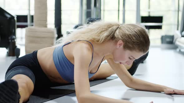 Fit Woman Doing Stretching While Sitting on Twine