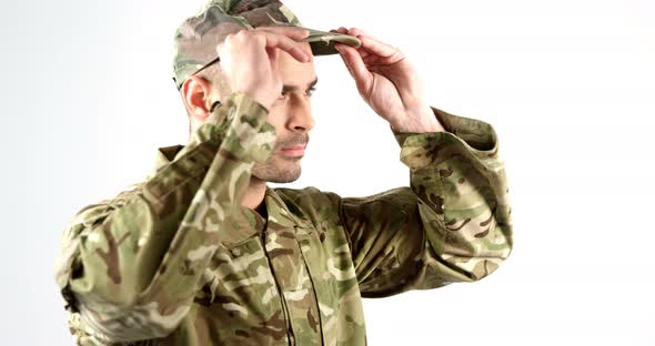 Soldier wearing patrol cap on white background