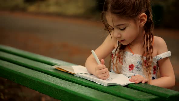 Cute Small Kid Girl Enjoying Creative Art. Adorable Preschool Child Learning Drawing Picture.