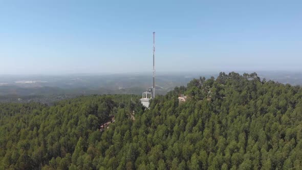 Aerial view of radio mast on top of Monchique mountain landscape during sunny day,Portugal