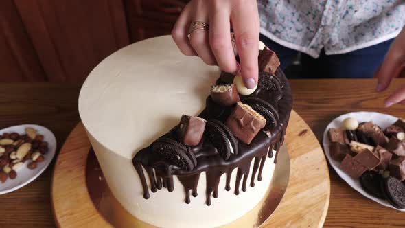 One person decorating a cake