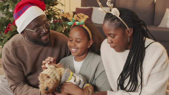 Happy African-American Family with Dog at Christmas