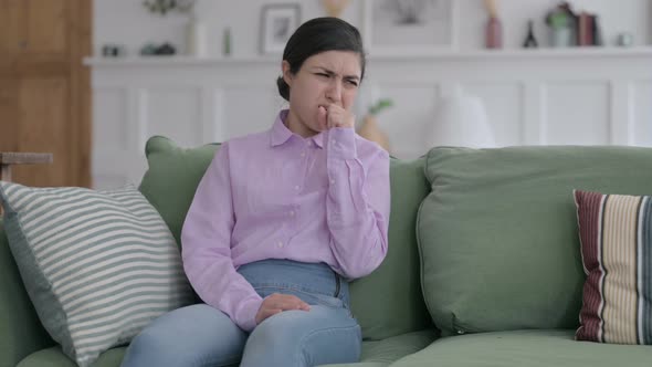 Indian Woman Coughing while Sitting on Sofa