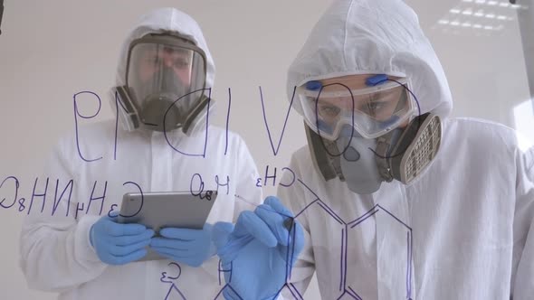 Two Doctors in Medical Suits Are Investigating the Covid-19 Virus in the Lab. alt