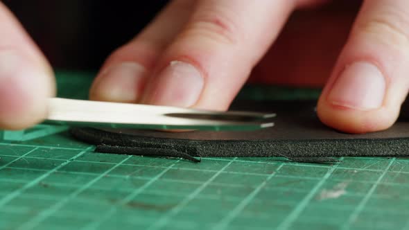 Man Tailor Cutting Artificial Leather Closeup