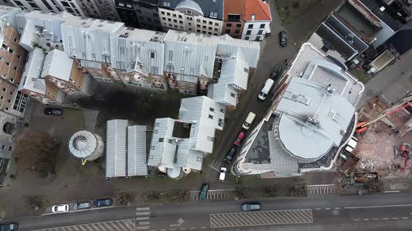 Ascending aerial top down shot of belgian housing area beside road with cars in Antwerp