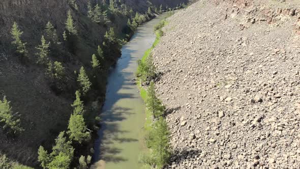 Broken Crumbled Rocks Spilling From the Narrow Canyon Slope Ridge Towards the Deep Valley Floor