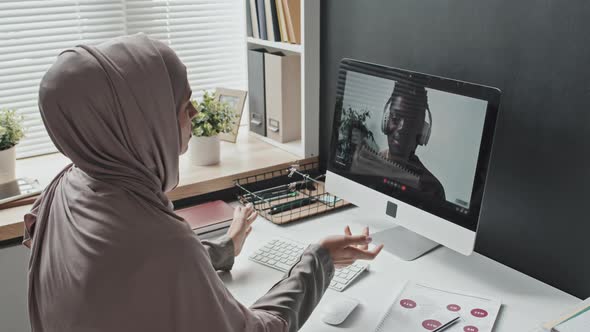 Muslim Woman Having Online Meeting on Web Call with Colleague