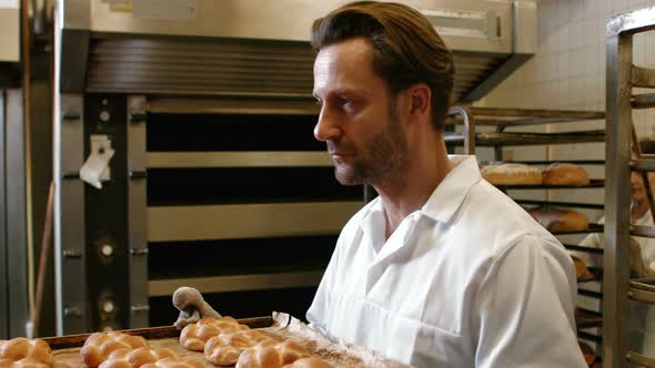 Bakers putting baked michetta in baking trolley