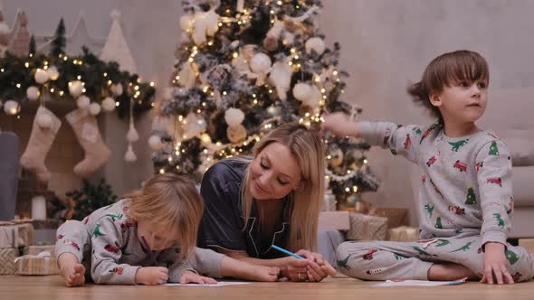 Happy Woman with Children Write Letters To Santa Claus Before Christmas