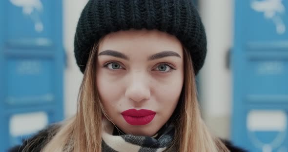 Female Portrait of Gorgeous Young Woman Adjusting Her Hair Looking Straight to Camera