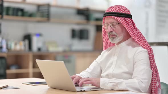 Appreciative Senior Old Arab Businessman with Laptop Doing Thumbs Up