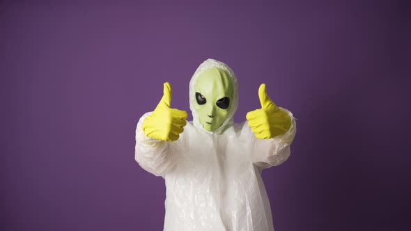 Alien Reptilian in Rubber Gloves Shows Thumbsup and OK Sign