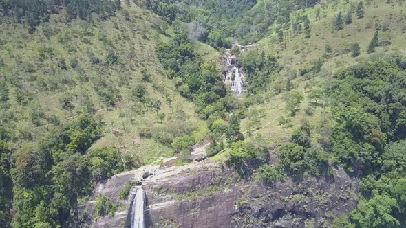 Diyaluma Falls on Steep Cliff with Cascades in Green Forest