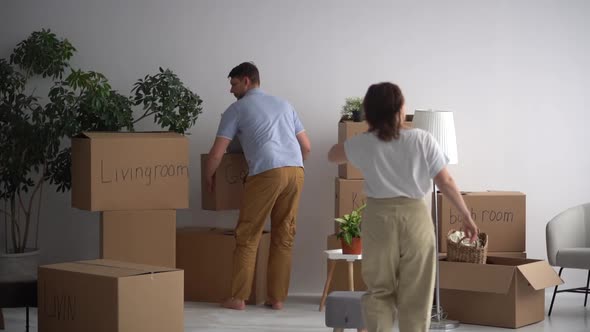 Married Couple Takes Out the Packed Things From the Apartment