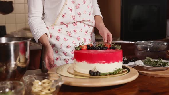 Woman Decorates the Cake in Home