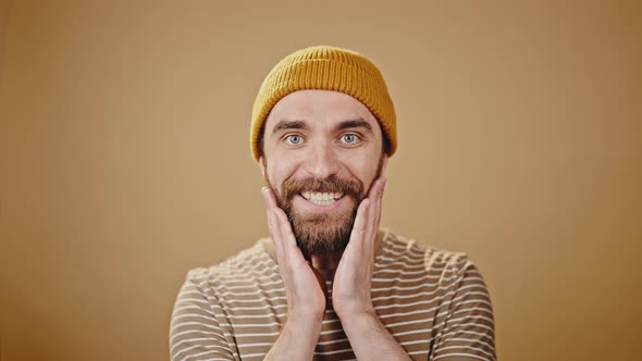 Mature Man in Hat Looks with Excited and Happy Expression