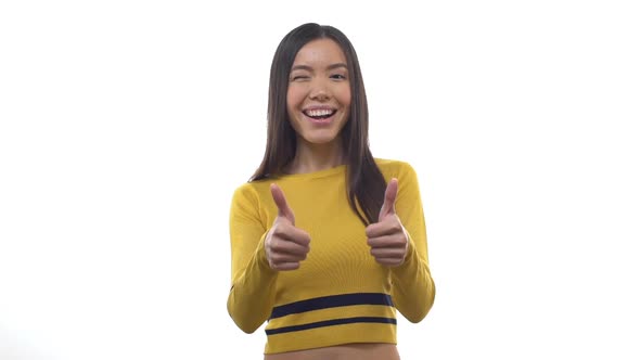 Slow Motion Ecstatic Goodlooking Feminine East Asian Girl Having Fun Showing Thumbs Up Gesture