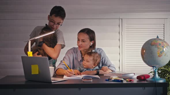 Stressed Mother with Small Children Working in Home Office Quarantine Concept