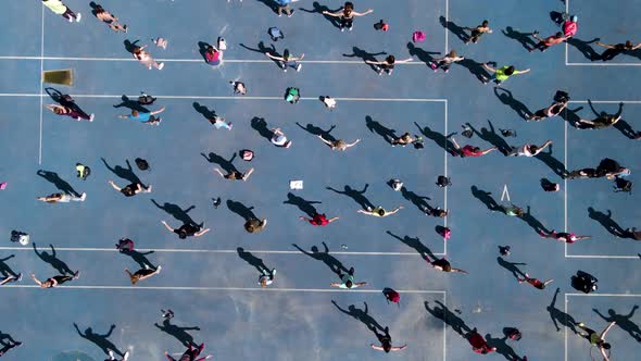 Aerial View From a Drone to a Group of People Who are Engaged in Gymnastics and Aerobics and Sports