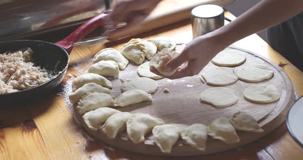 The process of making homemade dumplings. Raw pierogi