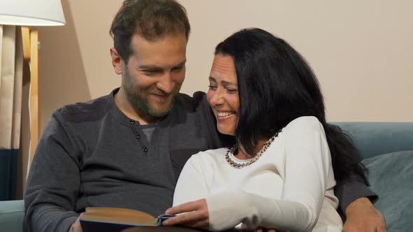 Lovely Married Mature Couple Laughing While Reading a Book Together 1080p