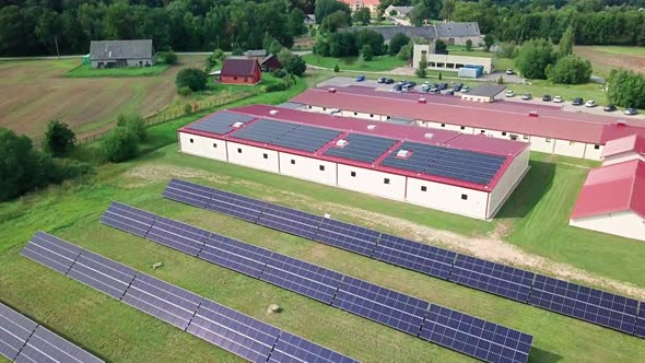 Solar panels on roof and yard at small factory (approx. 700 panels with 250 kW power)