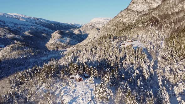 Wide open amazing dreamy winter landscape, Aerial moving backwards from mountain revealing remote fa