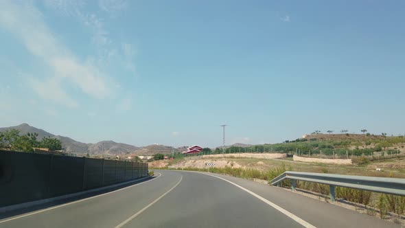 The View From the Window of a Car That Rides on a Beautiful Road.