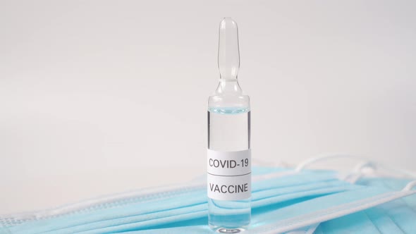 Glass ampoule with a clear liquid named COVID-19 VACCINE 