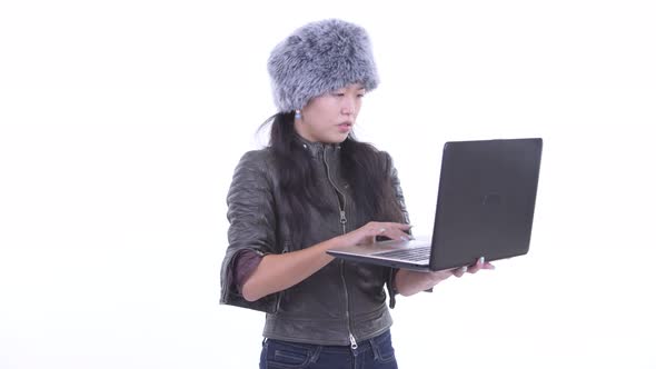 Happy Beautiful Asian Woman Thinking While Using Laptop
