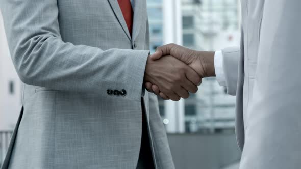 African American Colleagues Shaking Hands on Street