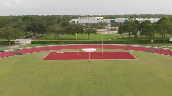Drone flight through goal post on a high school football field - super smooth aerial