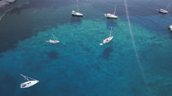Sailing Yachts Anchored in the Bay with Clear and Turquoise Water