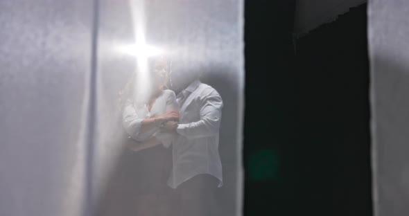 Behind Curtain Visible Couple Practicing First Wedding Dance Partners Focused on Each Other Handsome