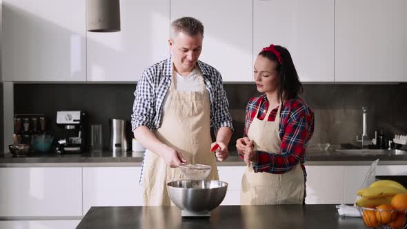 The Couple Sifting Flour to Make Bread and Bakery in Kitchen