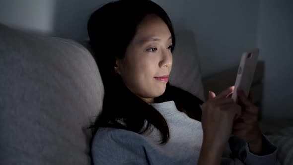 Woman working on digital tablet at night